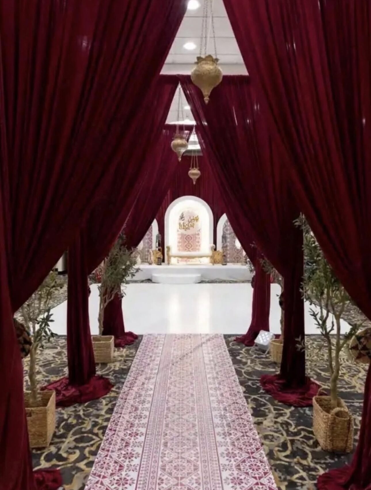 Burgundy velvet drape entrance corridor with olive trees